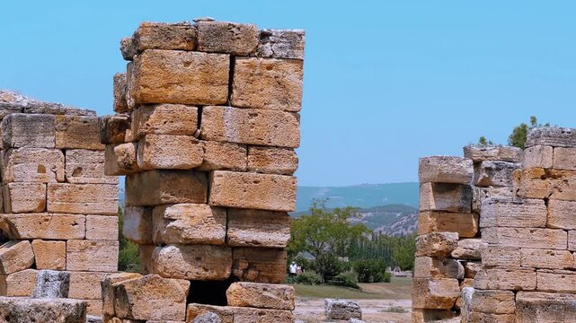 HIERAPOLIS in Denizli, TURKEY, August 13, 2024: The ancient city of Hierapolis near Pamukkale, against the backdrop of nature and mountains. The Phrygian period.UNESCO.4K