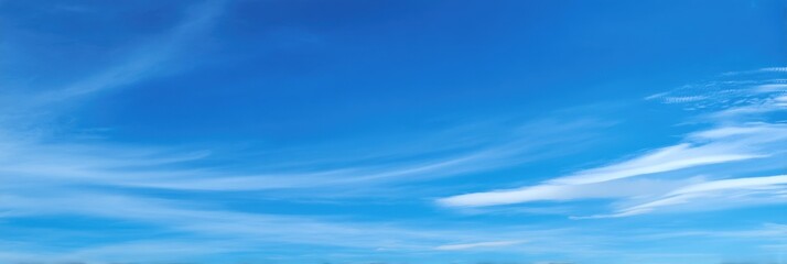 Clear blue sky with wispy clouds
