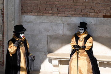 Venice, Italy - People dressed in carnival masks are photographed by tourists in the scenery of the...
