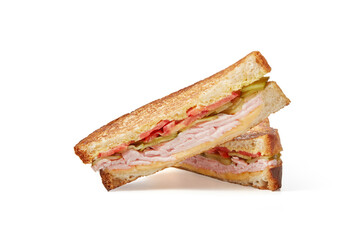 Two slices of club sandwich made with ham, cucumber, cheese and tomato isolated
