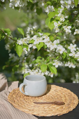Enjoying coffee surrounded by blooming flowers in a sunlit garden