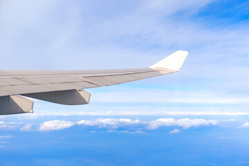 View from airplane window, airplane wing and beautiful cloudy sky.