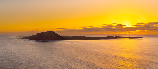 Spectacular golden hour sun rise image of the view over the volcanic island Isla de Lobos, near Corralejo, Fuerteventura, Canary Islands Spain