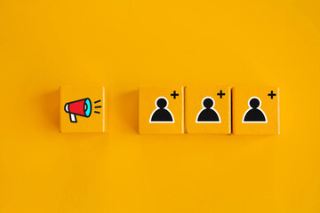 Business marketing strategies use advertisements to attract new customers ; Megaphone and people...
