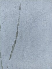 Grungy White Wall with Dark Stains and Brush Texture. Close-up of a white wall surface with dark paint drips, stains, and textured brush strokes. Ideal for grunge design backgrounds