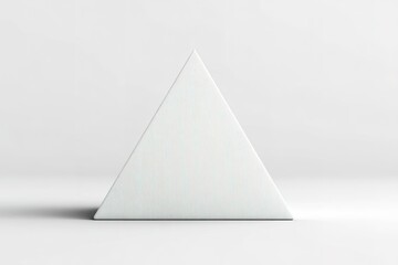 Fototapeta premium Minimalist geometric triangle sculpture placed on a smooth surface with soft lighting during a neutral decor setting
