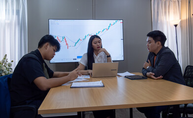 Business meeting on stock analysis, discussing market trends with digital tools