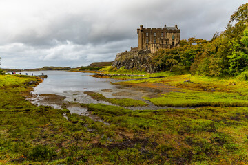 Dunvegan Castle overlooks the Isle of Skye’s coast, surrounded by manicured gardens, exotic...