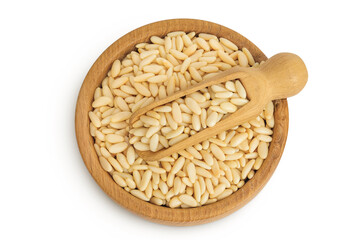 Shelled European pine nuts in wooden bowl and scoop isolated on white background. Top view. Flat lay