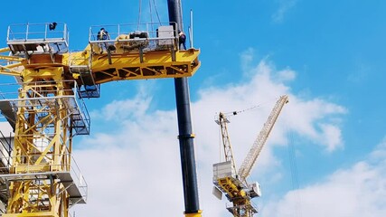 Tower crane or mobile crane erected beside under construction building.
Yellow color Tower crane lifting heavy items from ground to top level
Building Portable Tower Cranes for under construction site - Powered by Adobe