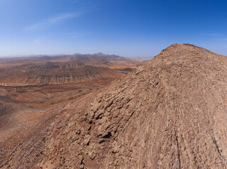 Dramatic aerial image of Montana Escanfraga and the volcanic mountain landscape and coastline near Villaverde in Fuerteventura Canary Islands Spain	