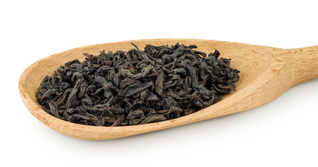 Dry black tea leaves in wooden spoon isolated on white background