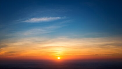 the morning sky where the sun is rising from the horizon