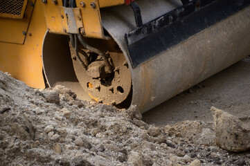 Soil compactor working on an earthmoving site, industrial machine, work, construction, engineering