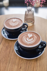 Cup of hot cacao with shape heart symbol of love, hot chocolate on a table. Shallow depth of field.