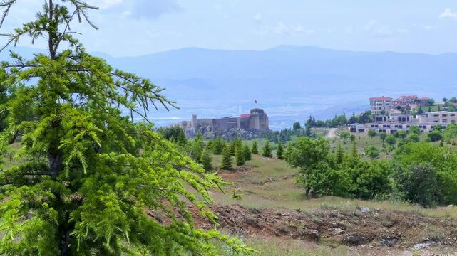 Harput fortress with the Turkish flag, in the spring in Eastern Anatolia, Elazig, Turkey. Harput Castle or Harberd, also known as Sut Kalesi. Ancient city. 4К