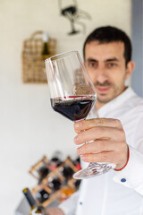 Glass of red wine in hands. Selective focus.