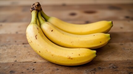 The photo shows a ripe sweet banana resting on a rustic wooden table, with its vibrant yellow skin contrasting beautifully against the natural wood grain