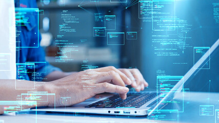 Close-up of hands typing on a laptop with holographic code and digital data interface overlays,...