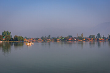 Naklejka premium View of Dal lake during sunrise and the beautiful mountain range in the background in the city of Srinagar, Kashmir, India.