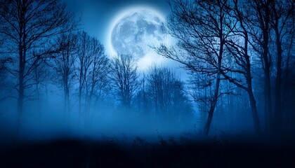 Fototapeta premium Spooky night foggy forest under the night sky with a full moon in cold blue tones Halloween backdrop