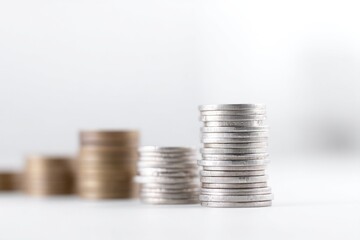 minimalistic arrangement of coins and banknotes symbolizing capital growth and wealth accumulation in clean white space