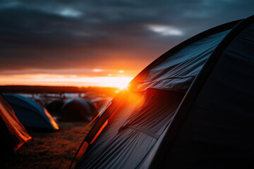 Fototapeta premium Sunset view of tents during a camping event in the mountains on a summer evening