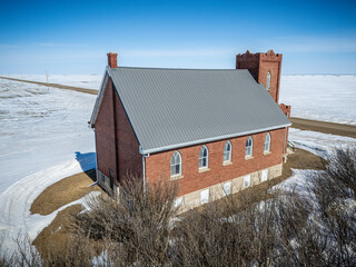 Church with a gray roof and a brick exterior