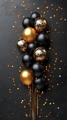 A festive arrangement of black, gold, and glittering balloons on a dark surface with confetti