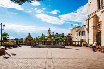 Majestic fountain adorns Piazza Plebiscito in Viterbo, Italy, showcasing intricate details and the charm of Italian architecture under a bright blue sky