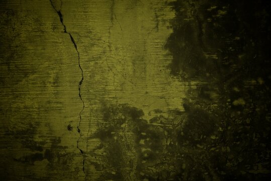cracked wall background with yellow rays, Background with an old concrete wall with an orange cracked paint lit by sun rays