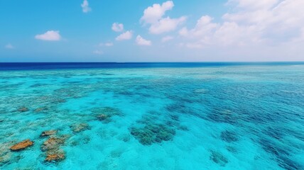 Fototapeta premium World oceans day with sustainability and protection idea. Vibrant turquoise ocean with coral reefs and clouds above.