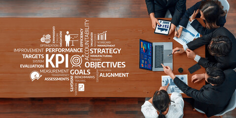 A diverse team engages in a strategic business meeting, analyzing key performance indicators and discussing objectives and goals for enhanced performance and accountability. Amity
