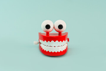 A jaw toy with teeth and eyes on a blue background