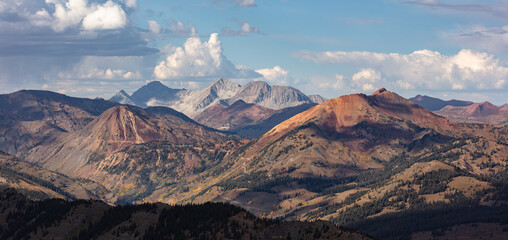 Fototapeta premium Mt Baldy and Cinnamon Peak overshadowed by Capitol Peak, Snowmass Mountain, and Haggerman Peak. Captured outside of Crested Butte Colorado in the Elk Range mountains.