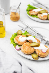 Vegan meat patties that cook like meat and have the same texture with green salad on a light concrete background. Delicious vegan food