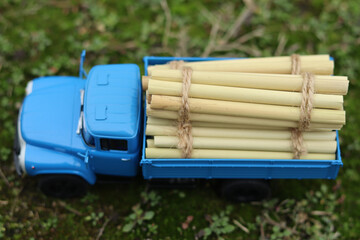 Scale model of a retro truck with a blue cabin and loaded with timber. Top view.