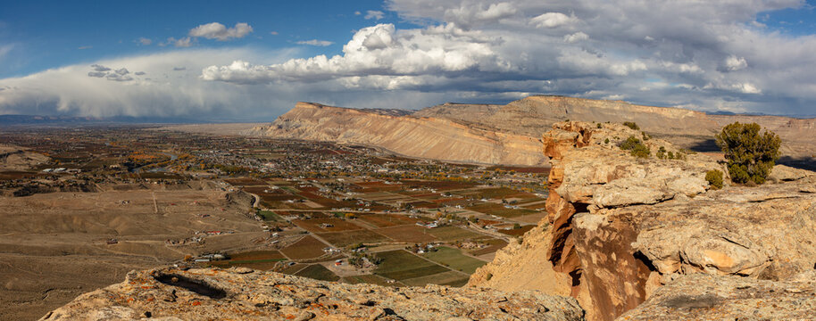 This panorama from near Palisade Colorado features The Grand Valley, The Colorado River, Mt Garfield, and the Book Cliffs. 