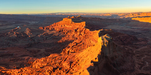Panorama of sunset on the rugged canyon desert topography from the Anticline overlook south of Moab Utah.