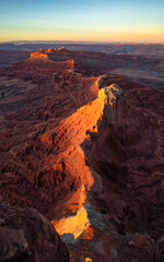 Sunset on the rugged canyon desert topography from the Anticline overlook south of Moab Utah.