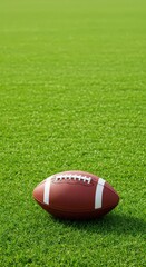 Obraz premium American football ball on vibrant green turf field for sport and game concept, great for active lifestyle, fitness, and championship celebration.