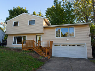 A split-level house with newly installed vinyl siding