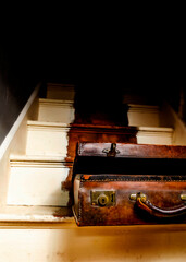 An old suitcase on wooden steps.