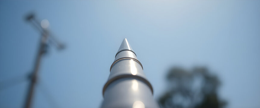 close up of a metal pole with trees in the background