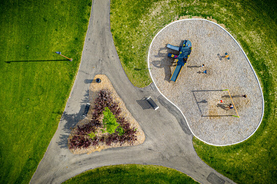 Park with a playground and a triangular flower bed
