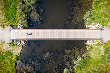 Bridge over a river with a person walking on it