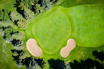 Golf course with a green grassy field and two sandpits