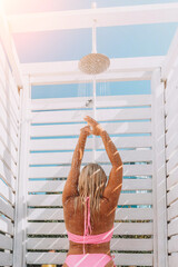 Beach Shower Woman Summer: Outdoor rinse after swimming, sunny day, relaxation.