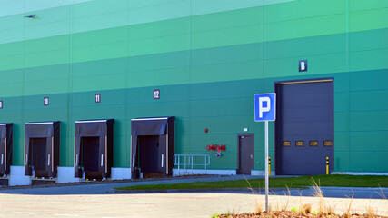 Facade of an industrial building and warehouse. Empty platforms at a distribution center.  