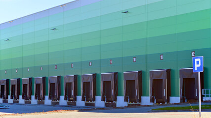 Facade of an industrial building and warehouse. Empty platforms at a distribution center.  
